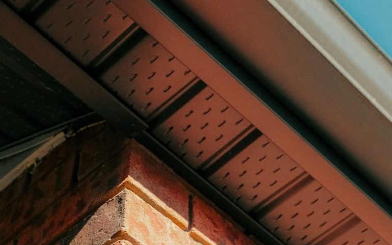 a close up of a brick building with a blue sky in the background